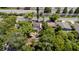 Aerial view of property with damaged roof surrounded by trees and next to highway at 3914 W Robinson St, Orlando, FL 32805