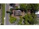 Aerial view of property with damaged roof surrounded by trees at 3914 W Robinson St, Orlando, FL 32805