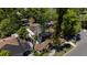 Aerial shot of an older home surrounded by trees with a damaged roof covered with a black tarp at 3914 W Robinson St, Orlando, FL 32805