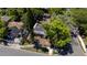 Birds eye view of an older home, showing the damaged roof, backyard shed, and surrounding trees at 3914 W Robinson St, Orlando, FL 32805