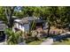 Shot of an older home with white siding, a damaged roof, and some debris in the front yard at 3914 W Robinson St, Orlando, FL 32805