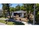 Street view of an older home with damaged roof and covered with a black tarp; overgrown front yard at 3914 W Robinson St, Orlando, FL 32805