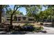 Exterior shot of the property shows an old home with wood stacked and garbage bags in front at 3914 W Robinson St, Orlando, FL 32805