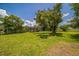Expansive backyard with well-maintained lawn and large trees, offering ample space at 426 Illinois Ave, St Cloud, FL 34769