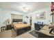 Comfortable bedroom with carpet flooring, a ceiling fan, a workspace, and a large bed at 426 Illinois Ave, St Cloud, FL 34769