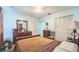 Well-lit bedroom with wood furniture and carpet at 426 Illinois Ave, St Cloud, FL 34769