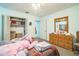 Cozy bedroom featuring a closet, dresser with decorative mirror, and comfortable furnishings at 426 Illinois Ave, St Cloud, FL 34769