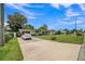 Single story home with well-kept lawn and mature trees; car parked in a long driveway at 426 Illinois Ave, St Cloud, FL 34769