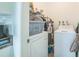 A functional laundry room with washer, dryer, and storage space at 426 Illinois Ave, St Cloud, FL 34769