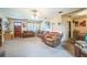 Comfortable living room featuring plush carpeting, ceiling fan, and traditional furnishings at 426 Illinois Ave, St Cloud, FL 34769