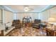 Spacious living room with paneled walls and wall-to-wall window at 426 Illinois Ave, St Cloud, FL 34769