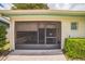 Enclosed back patio with screens, roll-up shades, and comfortable seating at 426 Illinois Ave, St Cloud, FL 34769