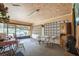 Covered sunroom with indoor/outdoor carpet and breeze block wall at 426 Illinois Ave, St Cloud, FL 34769