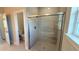 Updated bathroom featuring a glass-enclosed shower with a tiled surround and chrome hardware at 4437 Sw 159Th Pl, Ocala, FL 34473