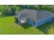 Backyard aerial view highlighting the lawn, covered patio, and gray exterior at 4911 Ne 7Th St, Ocala, FL 34470