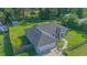 Aerial view of a well-maintained home with a large yard, black roof, and fenced perimeter at 4911 Ne 7Th St, Ocala, FL 34470