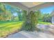 Enclosed back porch with a concrete foundation and lush greenery, creating a tranquil outdoor retreat at 4911 Ne 7Th St, Ocala, FL 34470