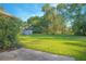 Large backyard with mature trees, offering ample space for recreation and relaxation in a peaceful setting at 4911 Ne 7Th St, Ocala, FL 34470