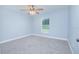 Bright, carpeted bedroom with natural light and ceiling fan at 4911 Ne 7Th St, Ocala, FL 34470