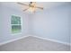 Bedroom with carpet, ceiling fan, and window at 4911 Ne 7Th St, Ocala, FL 34470