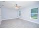 Spacious bedroom with new floors, ceiling fan, and ample natural light at 4911 Ne 7Th St, Ocala, FL 34470