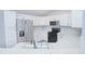 Bright kitchen featuring white cabinets, stainless steel appliances, and speckled countertops at 4911 Ne 7Th St, Ocala, FL 34470