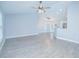 Open-concept living room and kitchen with vinyl floors, vaulted ceilings and modern fixtures at 4911 Ne 7Th St, Ocala, FL 34470