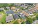 Aerial view of a neighborhood street and well-maintained homes featuring solar panels, backyard pools, and beautiful landscaping at 561 Gunston Ct, Davenport, FL 33837