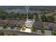 Stunning aerial view of a lakeside home with solar panels and lush landscaping in a vibrant neighborhood at 561 Gunston Ct, Davenport, FL 33837