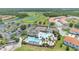 An aerial view showcases the clubhouse with pools, a playground, tennis courts, ample parking and green landscaping at 561 Gunston Ct, Davenport, FL 33837