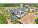 An aerial view captures a backyard pool and solar panels on the roof of a home in a residential neighborhood at 561 Gunston Ct, Davenport, FL 33837