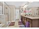 Large bathroom featuring double sink vanity with granite countertop and glass shower at 561 Gunston Ct, Davenport, FL 33837