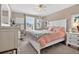 Cozy bedroom with a window desk, ceiling fan, and pink bedding at 561 Gunston Ct, Davenport, FL 33837
