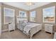 Bright bedroom with a white bed frame, neutral walls, carpeted floors, and windows that let in plenty of natural light at 561 Gunston Ct, Davenport, FL 33837