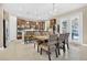 Bright dining area adjacent to kitchen, featuring stylish table setting and modern appliances at 561 Gunston Ct, Davenport, FL 33837