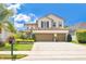 Beautiful two-story home with a three-car garage, manicured landscaping, and a well-maintained lawn at 561 Gunston Ct, Davenport, FL 33837