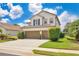 A well-maintained home with a spacious driveway and manicured landscaping on a sunny day at 561 Gunston Ct, Davenport, FL 33837