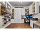 Cozy home office featuring built-in shelving, a Murphy bed, a flat screen television, and hardwood floors at 561 Gunston Ct, Davenport, FL 33837