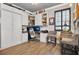 Home office features custom built-ins, a Murphy bed, modern desk space, hardwood floors, and a stylish barrel table at 561 Gunston Ct, Davenport, FL 33837