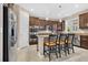Modern kitchen with stainless steel appliances, granite countertops, and a breakfast bar at 561 Gunston Ct, Davenport, FL 33837