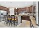 Spacious kitchen with stainless steel appliances, dark wood cabinetry, and center island seating at 561 Gunston Ct, Davenport, FL 33837