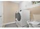 Laundry room features modern, front-loading washer and dryer units, and built in shelving above at 561 Gunston Ct, Davenport, FL 33837