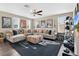 Inviting living room with large sectional sofa, ceiling fan, and a gallery of posters at 561 Gunston Ct, Davenport, FL 33837