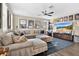Inviting living room with large sectional sofa, ceiling fan, and a gallery of posters at 561 Gunston Ct, Davenport, FL 33837