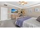 Comfortable bedroom with large dresser, decor wall, TV, and neutral colors at 561 Gunston Ct, Davenport, FL 33837