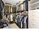 Organized walk-in closet with custom shelving, hanging racks, and drawers at 561 Gunston Ct, Davenport, FL 33837