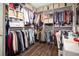 Organized walk-in closet with custom shelving, hanging racks, and wood floor at 561 Gunston Ct, Davenport, FL 33837