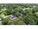 This aerial view showcases a charming home nestled among lush greenery in a peaceful neighborhood at 7330 Canal Dr, Sanford, FL 32771