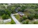An aerial shot shows the home's tranquil location and spacious yard surrounded by lush trees at 7330 Canal Dr, Sanford, FL 32771