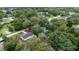 This aerial view showcases a charming home nestled among lush greenery in a peaceful neighborhood at 7330 Canal Dr, Sanford, FL 32771